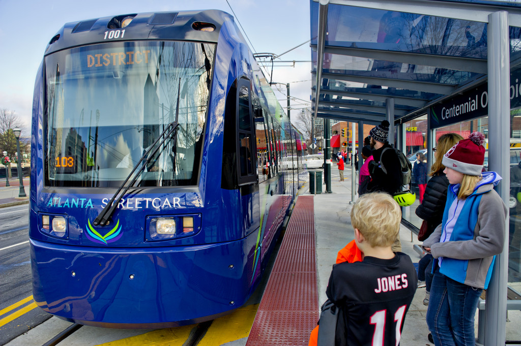 December 31, 2014 Atlanta - Shelby Jones (right) and her brother Dalton wait at the Centennial Olympic Park stop as an Atlanta Streetcar pulls up on Wednesday, December 31, 2014. Each streetcar can hold up to 200 riders. The new service takes about 30 minutes to make a round trip for each of the 12 stops. JONATHAN PHILLIPS / SPECIAL