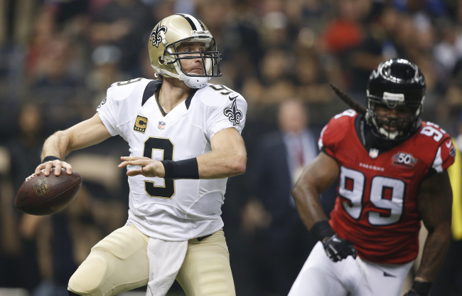New Orleans Saints quarterback Drew Brees (9) works as Atlanta Falcons defensive end Adrian Clayborn (99) pursues during the first half of an NFL football game, Thursday, Oct. 15, 2015, in New Orleans. (AP Photo/Gerald Herbert)