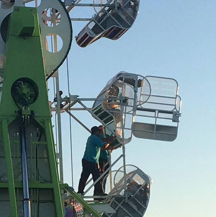 Employees helping children out of malfunctioned ride