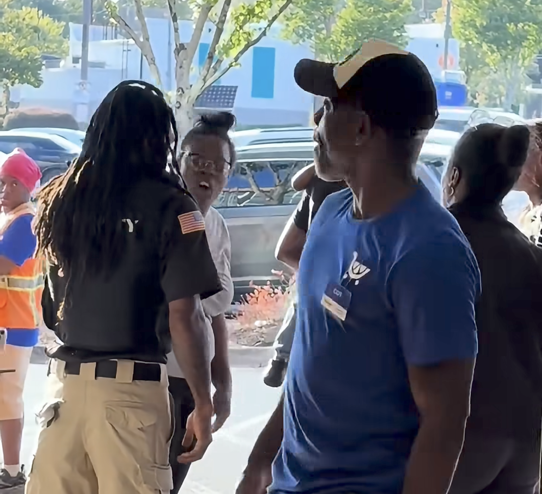 People gathered near a store entrance during the Cascade-area Kroger confrontation.