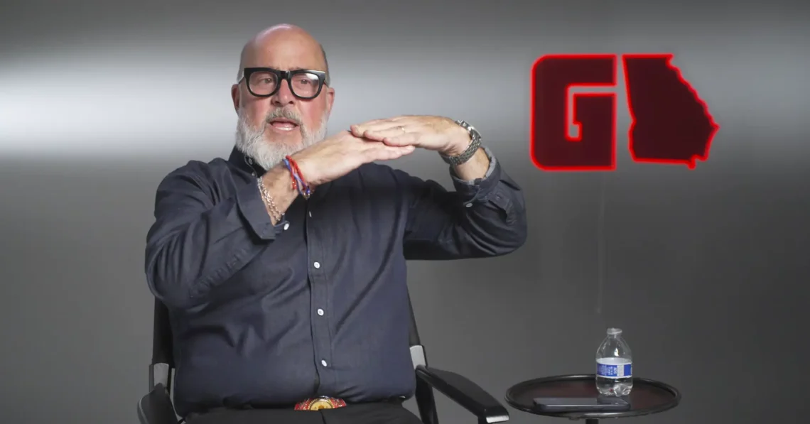 Interview guest seated in the GAFollowers studio beside a red Georgia-shaped logo.