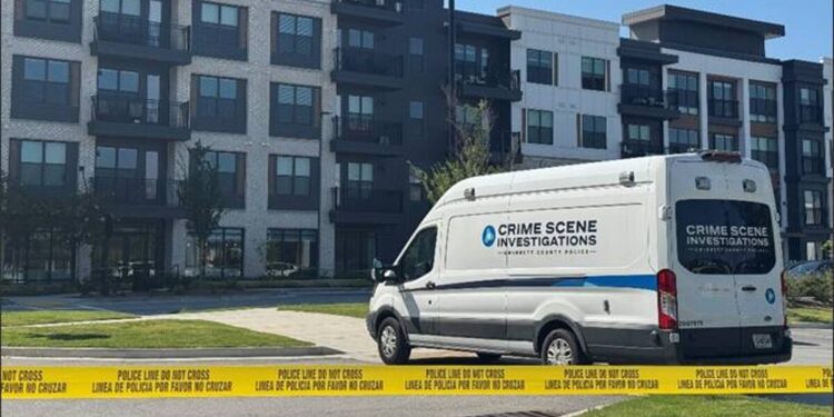 Police crime scene vehicles outside a Buford apartment complex