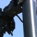 Close-up of a fire-damaged Flock Safety camera mounted on a pole in Cobb County.