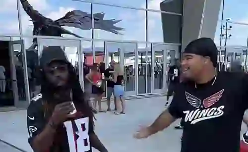 Jalen of @wings.atl interviewing an Atlanta Falcons fan during GAFollowers game-day coverage.
