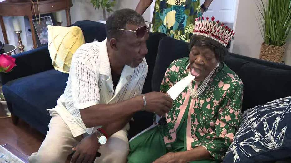 Mabel Dunbar speaking with a family member during her birthday celebration